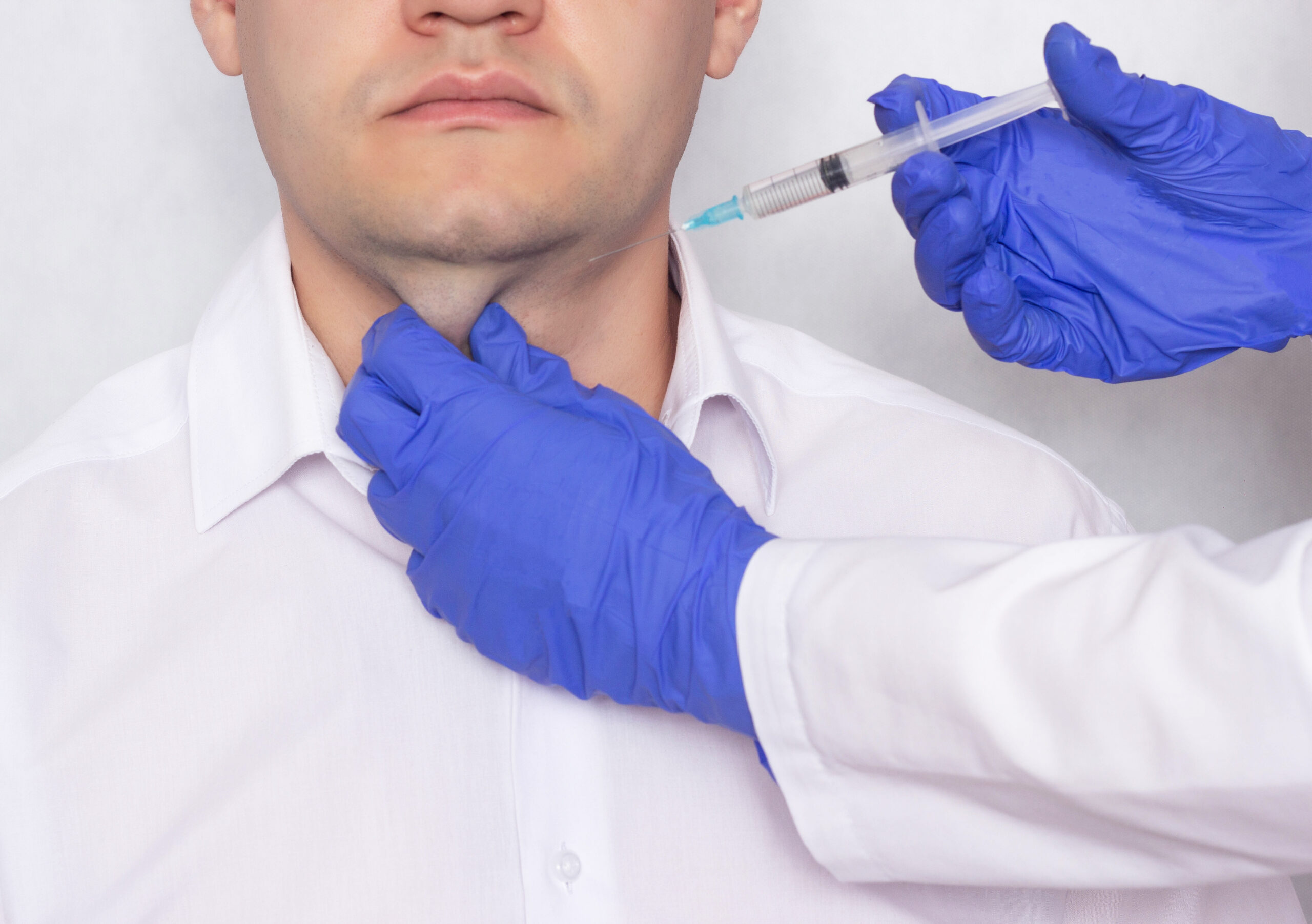 The doctor makes the patient in a double chin lipolitic injection, cosmetic and plastic, close-up